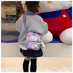 Detail of purple crossbody kids bag with colorful heart prints and cute bunny pendant