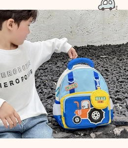 Detail of cute cartoon tractor embroidery and side mesh pocket on blue kids backpack