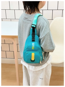 Rear view of a child wearing a blue crossbody chest bag with yellow straps and logo