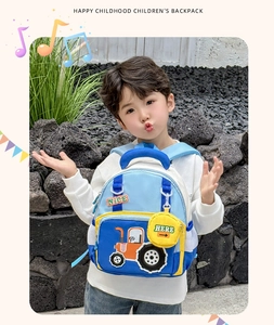 Close-up of children's blue backpack with orange tractor cartoon and yellow side pouch