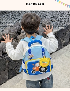 Close-up of kids tractor backpack with side coin purse and double zipper detail