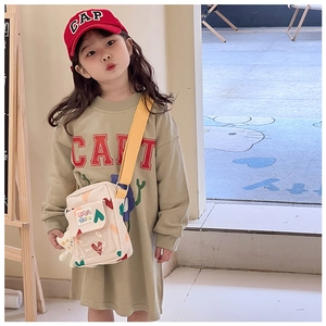 Kids cream heart print crossbody bag shown in a stylish autumn outfit arrangement