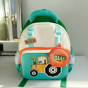 Detail of mint green kids backpack featuring a yellow tractor patch and orange coin purse