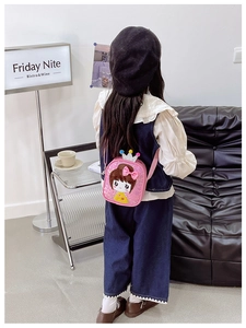 Pink sequin crossbody bag with cartoon girl and crown detail shown on child model