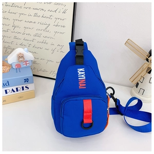 Detail of royal blue kid's chest bag featuring orange zippers and KAYINAI logo