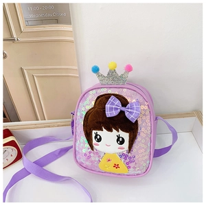 Detail of purple sequin girls crossbody bag with crown decor and colorful pom-poms