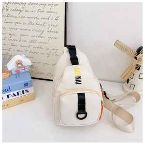 Close-up of off-white kids chest bag with KAYINAI logo and adjustable strap