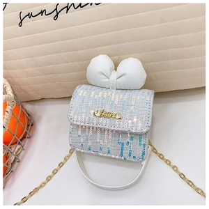 Detail shot of blue tweed girl's handbag with leather bow and golden Love charm buckle