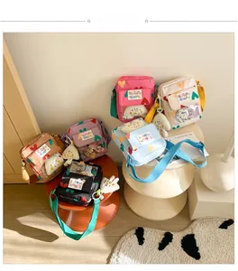 Collection of colorful canvas heart crossbody bags with transparent PVC front pocket and charms