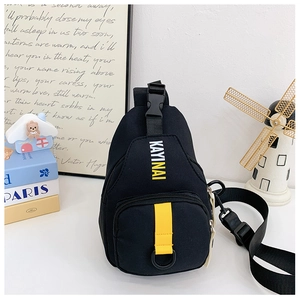Detail of trendy black kids chest bag with KAYINAI letters and adjustable yellow strap