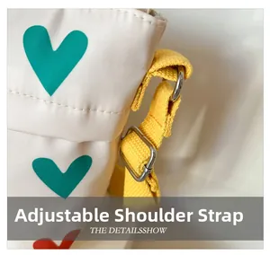 Détail de la bandoulière réglable en nylon jaune et boucle argentée sur sac en toile