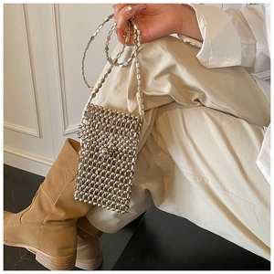 Détail du mini sac bandoulière à perles argentées avec finition brillante et chaîne