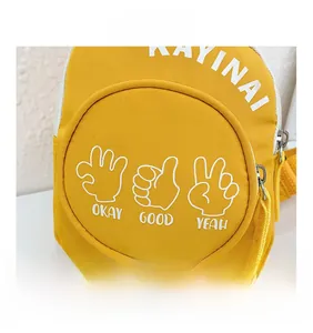 Detailed close-up of yellow canvas kids chest bag featuring trendy graphic hand prints