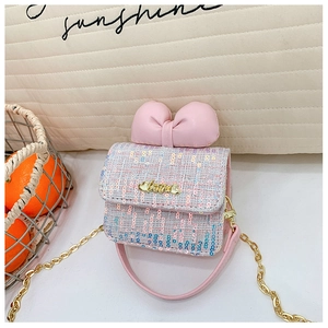Detailed shot of pink bow crossbody bag with glitter tweed fabric and golden Love charm