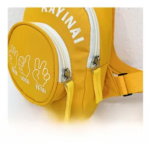 Detail of yellow canvas kids bag featuring smooth white zipper and cute hand gestures