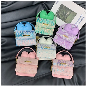 Close-up of macaron color mini crossbody bags with sequins and 3D bow details