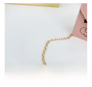 Detail of pink PU leather kids mini bag featuring gold metal chain and cute cartoon print