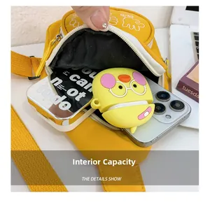 Detailed interior storage view of yellow kids chest bag with phone and notepad