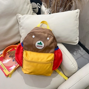 Detail of color-block kids backpack with waterproof nylon fabric and stitched logo patch