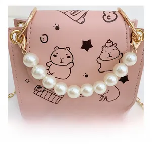 Pink pearl handle girl handbag with cute capybara print and golden chain strap detail