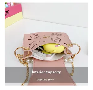 Pink cartoon animal crossbody bag showing internal capacity and pearl chain detail