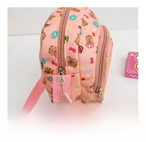 Close-up of pink kids crossbody bag showing smooth zippers and cute cartoon bear prints