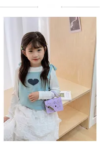 Toddler girl modeling light purple cartoon bear handbag with gold chain strap