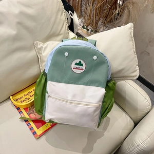 Close-up of canvas texture and brand logo on contrast color kids backpack