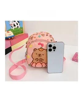 Detailed comparison of pink capybara kid's crossbody bag size against a smartphone