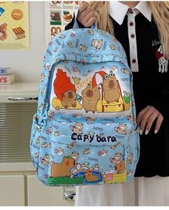 Detail of blue canvas backpack featuring cute Capybara cartoon prints and spacious pockets