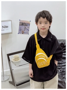 Detail view of the yellow canvas kids chest bag with adjustable strap and small front pocket