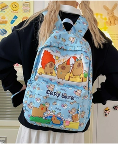 Detail of light blue backpack featuring cute Capybara prints and spacious front pocket