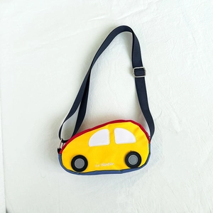 Detail of cartoon car chest bag showing yellow canvas fabric and adjustable strap