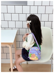 Detail of purple children crossbody bag with cute Capybara print and adjustable strap
