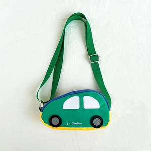 Detailed view of car-shaped kids chest bag with green canvas and adjustable strap