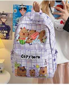 Close-up of cute purple plaid backpack featuring cartoon capybara prints and zipper pocket