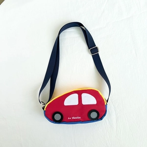Detail of red car-shaped kids chest bag with adjustable navy nylon shoulder strap