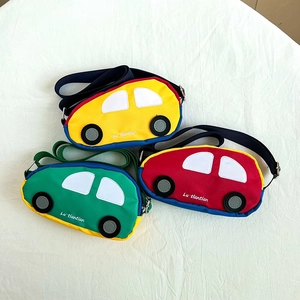 Close-up of three colorful car-shaped kids bags with adjustable straps in yellow red green