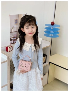 Pink mini crossbody bag for kids featuring a cute cartoon chick pattern and gold chain