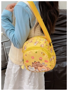 Detailed shot of yellow nylon kids crossbody bag with cute animal patterns and zipper