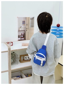 Rear view of a child wearing a dark blue sporty crossbody chest bag with adjustable strap