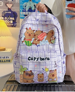 Detail view of purple plaid backpack featuring cute Capybara illustrations and front pocket