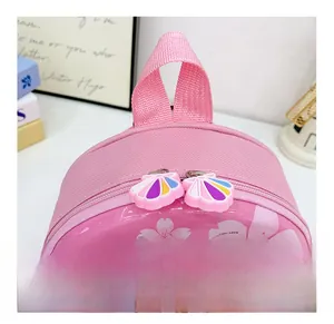 Close-up of pink hardshell backpack featuring smooth double zippers and cartoon graphics