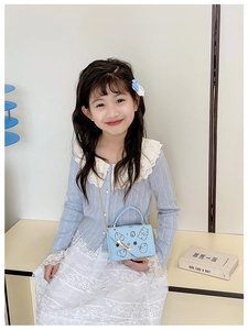 Mini light blue kids handbag featuring cute cartoon bear print and gold chain strap