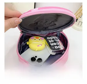 Pink round hardshell backpack interior showing space for phone and accessories
