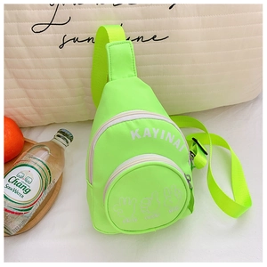 Detail of neon green nylon chest bag featuring letter print and black plastic buckles
