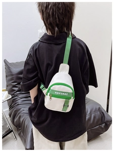 Kid's white crossbody chest bag with green straps and KAYINAI lettering details