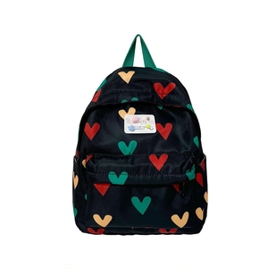 Black kids backpack featuring colorful heart prints and green webbing handles