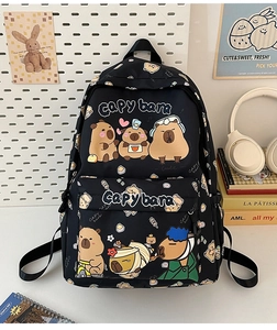 Close-up of black backpack featuring cute capybara prints with school supplies background