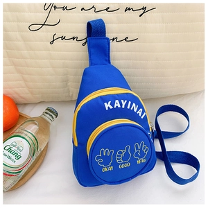 Detail view of a bright blue canvas kids crossbody bag with yellow zippers and letter prints